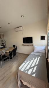a bedroom with a large bed and a table at Base de los Andes 4 in Maipú