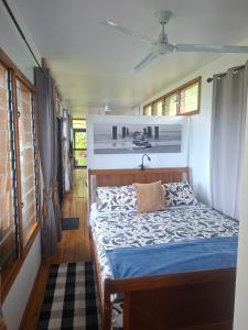 a bedroom with a bed with a blue comforter at Luna Studio in Apia