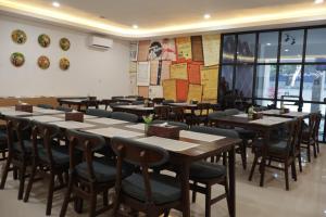 a row of tables and chairs in a restaurant at Aisyi Tower Klaten in Klaten