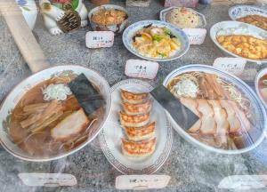 a table with plates of food and bowls of food at Goddessガッデス in Yokosuka
