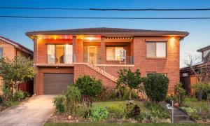 a brick house with a porch and a garage at Kaban Power 11 in Marayong