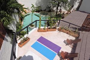 an overhead view of a pool with chairs and a table at Casa Wayra Tulum - Boutique Condos in Tulum