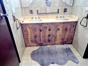 a bathroom with a wooden vanity and two sinks at Kaban Power 11 in Marayong +40 photos
