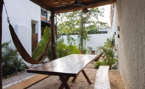 a hammock on the porch of a house at Casa Wayra Tulum - Boutique Condos in Tulum +61 photos