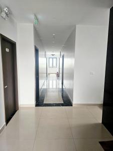 a hallway of a building with white walls and doors at TRƯỜNG THỊNH Hotel in Hòn Tru +10 photos