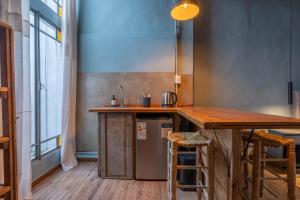 a kitchen with a wooden counter and a sink at La Piamonte 1903 in Azcuénaga