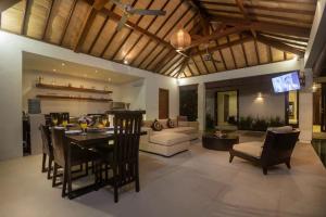 a living room with a kitchen and a dining room at Arama Riverside in Legian