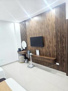 a bathroom with a tv on a wooden wall at TRƯỜNG THỊNH Hotel in Hòn Tru