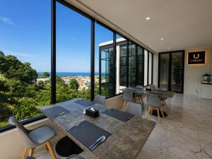 a conference room with tables and chairs and large windows at Karon Utopia in Karon Beach +44 photos