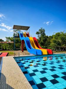 a colorful slide in a swimming pool at Villa Bumi Detani in Selabintana