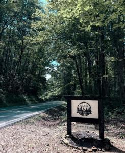 a sign sitting on the side of a road at Little Bear Tiny Cabin in Cosby +8 photos