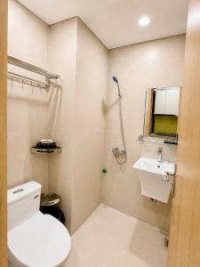 a bathroom with a toilet and a sink at Urban Nest - Cầu Giấy in Hanoi +9 photos