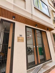 a building with two doors with bars on it at Urban Nest - Cầu Giấy in Hanoi