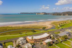 an aerial view of a resort and the beach at Seaview Studio Apartment - Beachfront with Heated Pool in Whitianga