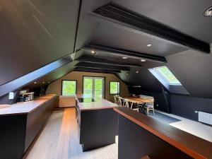 a large kitchen with counters and tables in a house at 4SEASONS - Golden Spring Suite in Aalborg