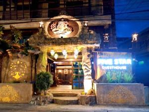 an entrance to a store at night with lights at Five Star Guest house in Chiang Mai