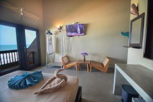a room with a room with a room with a room at At Ease Beach Hotel in Hikkaduwa