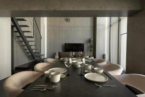 a dining room with a black table and chairs at ARTK'SJosui in Fukuoka