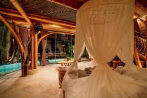 a bedroom with a bed with mosquito netting at Jiva Bali - Green Dream Suites in Selat