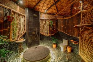 a bathroom with a shower and a toilet in it at Jiva Bali - Green Dream Suites in Selat
