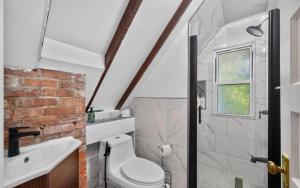 a bathroom with a white toilet and a sink at Studio Apartment in Smithtown +5 photos
