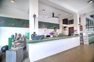 two people sitting at a counter in a store at At Ease Beach Hotel in Hikkaduwa +47 photos