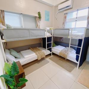 a room with three bunk beds in it at 綠島夏御 微熱海岸 Coast Venus in Green Island