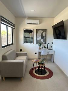 a living room with a couch and a table at Temptika Villa 3, New in Tempate