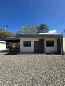 a small white house with a garage at Temptika Villa 2, New Property in Tempate
