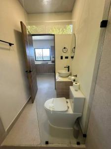 a bathroom with a toilet and a sink at Temptika Villa 2, New Property in Tempate +6 photos