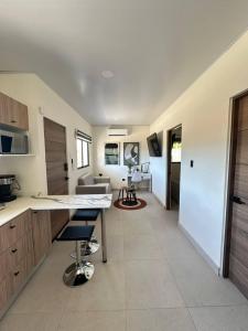 a kitchen with a counter and a living room at Temptika Villa 1, New Property in Tempate