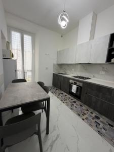 a kitchen with a table and chairs and a stove at Perla Azzurra in Savona