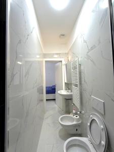a bathroom with a toilet and a sink at Perla Azzurra in Savona +27 photos