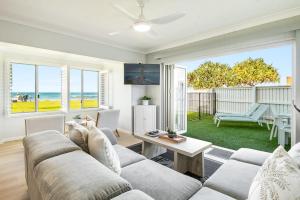 a living room with a couch and a table at Apartment 4B in Lennox Head