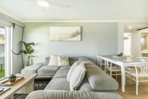 a living room with a couch and a table at Apartment 4B in Lennox Head
