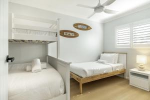 a bedroom with two bunk beds and a ceiling fan at Apartment 4B in Lennox Head