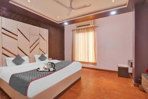 a bedroom with a bed and a projection screen at Super Collection O Hotel Blueline in Juhi Bari