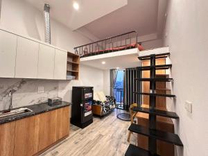 a kitchen with a loft bed and a living room at Urban Nest - Đông Ngạc in Hanoi