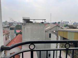 a view of a city from a balcony with an airplane at Urban Nest - Đông Ngạc in Hanoi