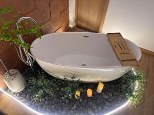 a bathroom with a bath tub with a potted plant at Urban Nest in Hanoi