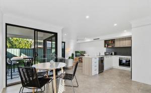 a kitchen and dining room with a table and chairs at Gemstone in Morayfield