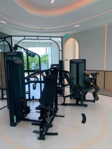 a gym with two treadmills and two ellipticals at The Title Serenity Naiyang in Ban Bo Han