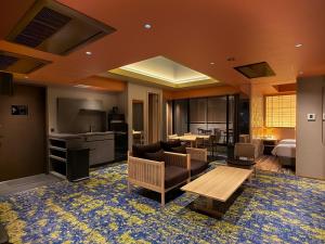 a living room with a couch and a table at Comforts81 DOTONBORI in Osaka +44 photos