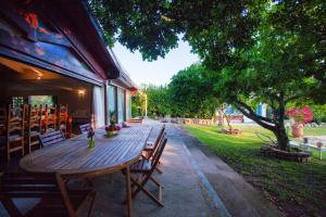a wooden table and chairs on a patio at Villa Niloan Olbia in Olbia
