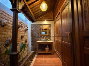a bathroom with a sink and a brick wall at Umah Nayoye Amed in Ambat +54 photos