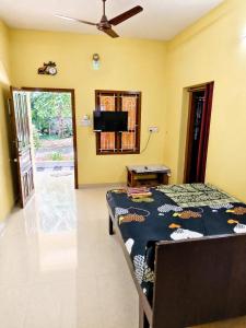a bedroom with a bed and a flat screen tv at DilsBreak HomeStay in Kanyakumari