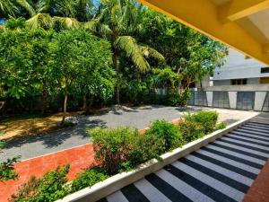 a staircase leading to a building with trees and plants at DilsBreak HomeStay in Kanyakumari