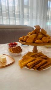 a table with two plates of bread and other foods at Guest house Kyial in Naryn