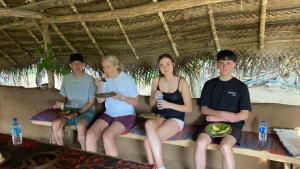 a group of people sitting on a bench at Joy Land Resort in Habarana +17 photos