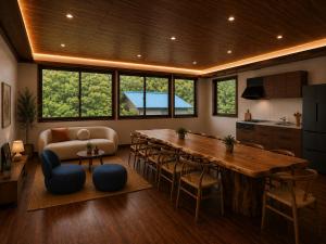a kitchen and living room with a large wooden table at LUX Niseko lodge in Niseko